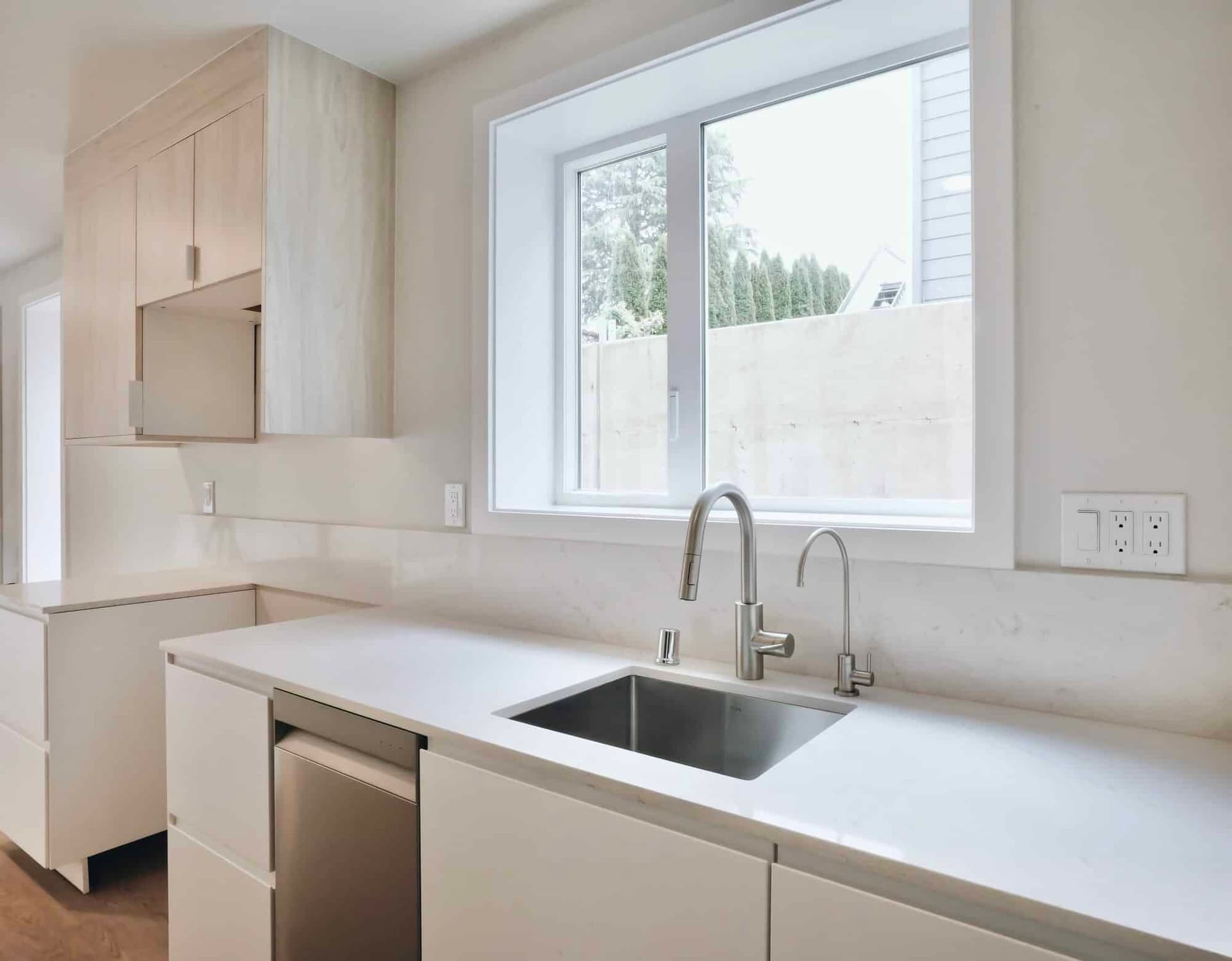 A finished bright white kitchen with flawless cabinetry and millwork by Strata Coating